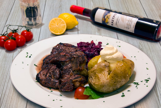 Kastro Oia Restaurant Santorini. Beef fillet with baked potato, fennel and red wine sauce.