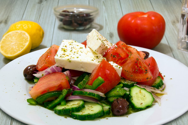 Kastro Oia Restaurant Santorini. Greek Salad with tomato, cucumber, onions, olives, capari, feta cheese, oregano and olive oil.